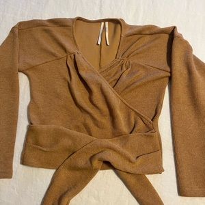 By anthropologie wrap sweater/top with pleating.